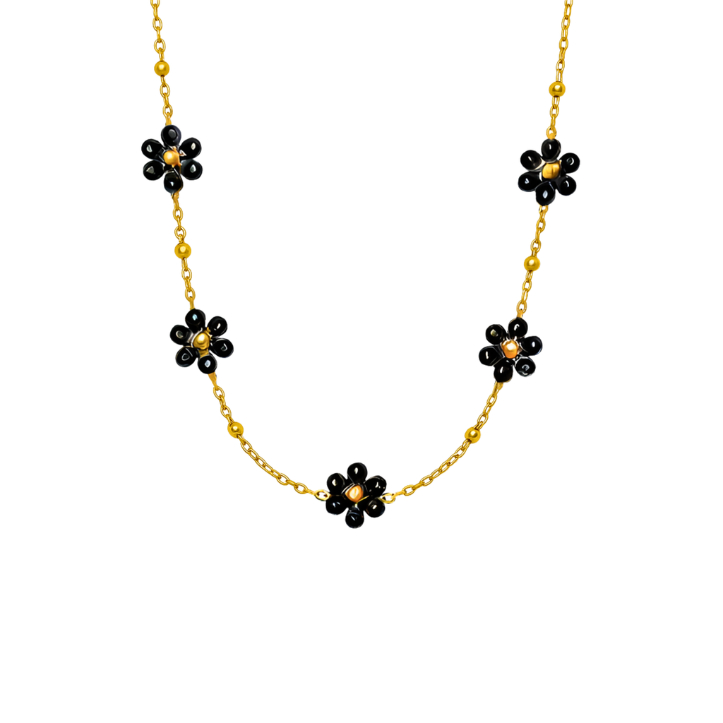 Goldene Halskette mit kleinen schwarzen Blumenanhängern